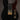 Black electric guitar with gold hardware on a dark background