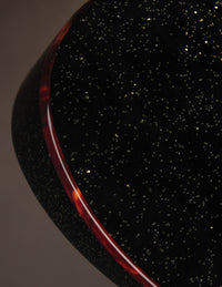 Close-up of a dark, textured surface with a subtle gradient