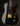 Glossy black electric guitar with gold hardware on a dark background