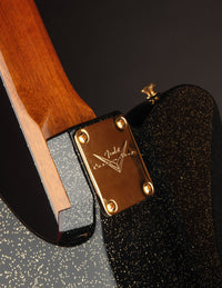 Close-up of a Fender guitar headstock with wooden finish