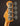 Close-up of a guitar headstock with tuning pegs on a dark background