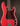 Red electric bass guitar with a dark brown tortoiseshell pickguard on a black background