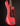 Red electric bass guitar on a black background