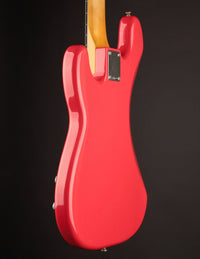 Red electric bass guitar back on a black background