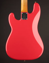 Red electric guitar with a visible brand logo on a black background