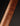 Close-up of a wooden guitar neck with a dark background