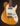 Electric guitar with a wooden body and white pickguard on a dark background