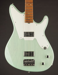 Green electric guitar with a white pickguard on a dark background