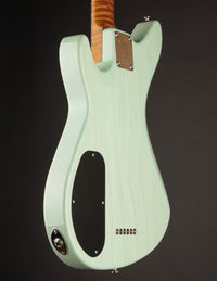 Light green electric guitar on a black background