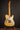 Electric guitar on a stand against a dark background