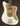 White colored Healy offset electric guitar with a gold pickguard against a dark background.