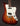 Sunburst colored Healy offset electric guitar against a dark background. 