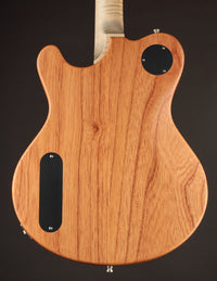 Wooden guitar body with a dark brown background