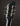 Close-up of a guitar headstock with tuning pegs on a dark background