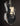 Black electric guitar with a white pickguard on a dark background