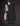 Black electric guitar on a dark background, back/side view 