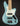 Turquoise electric bass guitar with a white pickguard on a black background