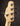 Close-up of a guitar headstock with tuning pegs on a dark background