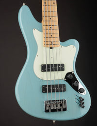 Light blue electric bass guitar with a dark background