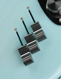Close up of faders on a blue electric bass