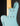Close-up of a light blue electric guitar body with a black background