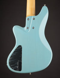 Light blue electric guitar on a dark background