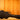 Black guitar case on a wooden surface with a wooden panel background