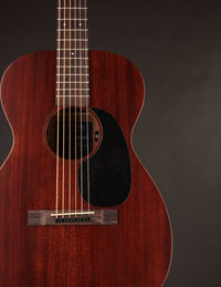 Close-up of a brown acoustic guitar on a dark background