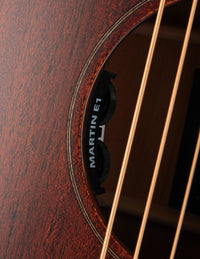 Close-up of a Martin acoustic guitar's soundhole with brand logo.