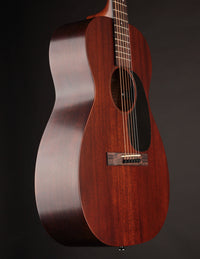 Acoustic guitar with a dark brown finish on a black background