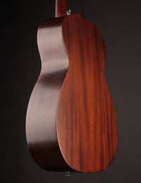 Close-up of a wooden guitar body on a dark background