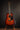 Martin acoustic guitar on a stand against a dark background