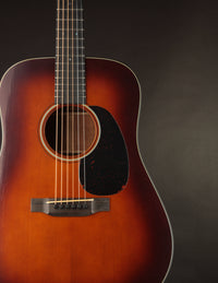 Martin acoustic guitar with a sunburst finish on a dark background