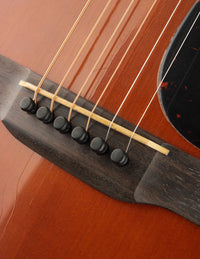 Close-up of a guitar's soundboard with strings and bridge