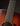 Close-up of an acoustic guitar's neck on a dark background