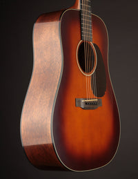 Martin acoustic guitar with a sunburst finish on a dark background