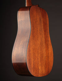 Back & side of a Martin acoustic guitar on a dark background