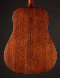 Martin acoustic guitar on a dark background, from the back