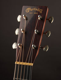 Guitar headstock with 'Martin & Co' branding on a dark background