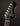 Close-up of a guitar headstock with 'Novo' branding on a dark background