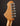 Close-up of a guitar headstock with tuning pegs on a dark background