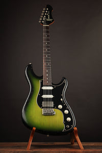 Green electric guitar on a stand against a dark background