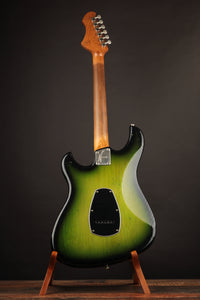 Green electric guitar on a stand against a dark background