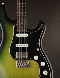 Green and black electric guitar on a dark background