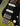 Close up of green and black electric guitar on a dark background