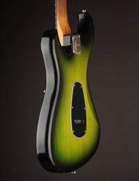 Green and black electric guitar on a dark background