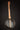 Banjo on a stand against a dark background, back view