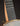 Close-up of a banjo's frailing scoop and strings against a dark background