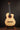 Classical guitar on a stand against a dark background