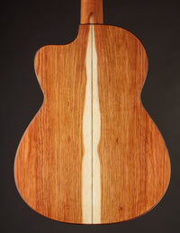 Back view of a classical guitar with a dark background
